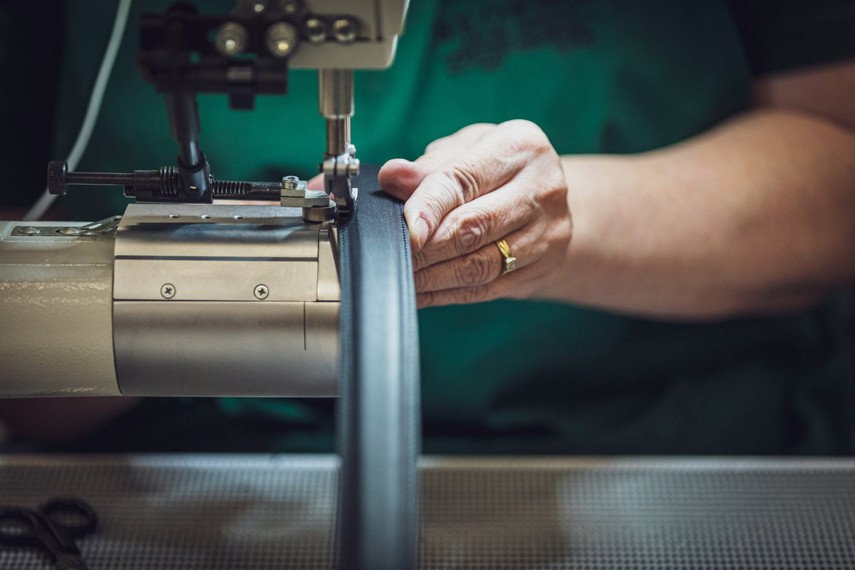 A Beorma maker stitching a bridle leather belt in the Walsall workshop